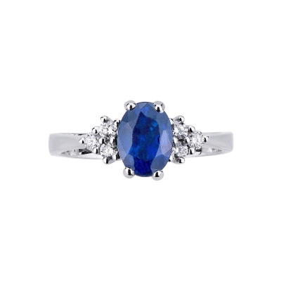 Bague en or blanc 18k avec diamants latéraux et saphir bleu