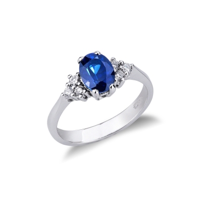 Bague en or blanc 18k avec diamants latéraux et saphir bleu